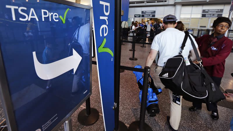 A passenger passes by a sign for the Transportation Security Administration’s TSA PreCheck line in Terminal A at Logan Airport in Boston, Monday, June 27, 2016. Teens ages 13 to 17 can now accompany their parents through TSA PreCheck if they are on the same reservation.