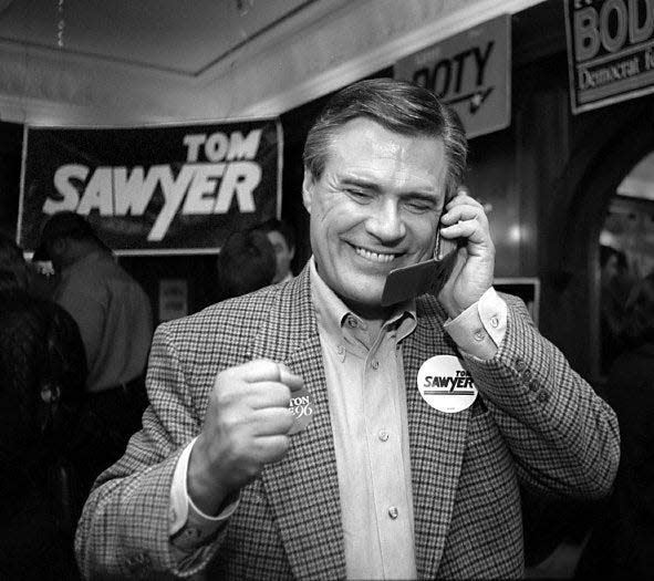 U.S. Congressman Tom Sawyer pumps his fist as we gets an update on election results in November 1996. Sawyer was at Liberty Street Brewing Company for his election party.