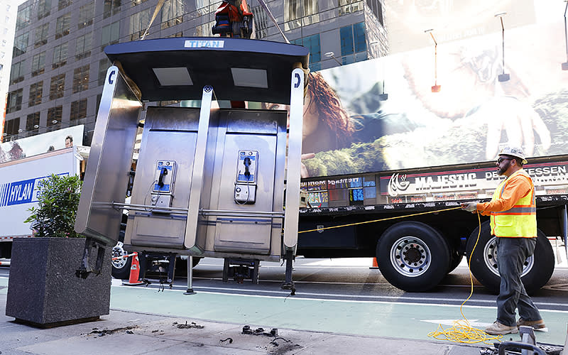 The last New York City public payphone is removed on Seventh Avenue on May 23. The city began removing payphones in 2015 and replacing them with public Wi-Fi hotspots. <em>John Angelillo/UPI Photo</em>