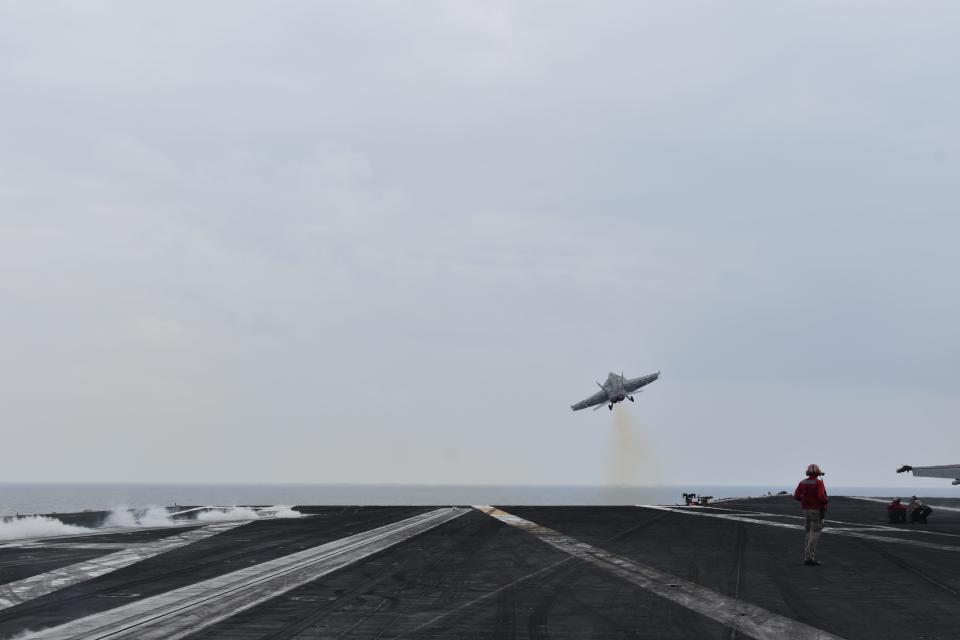 A fighter jet takes off from the USS Dwight D. Eisenhower.