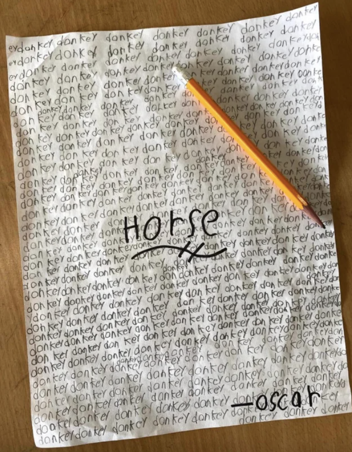 Horse written on a sheet of paper that says "donkey" repeatedly