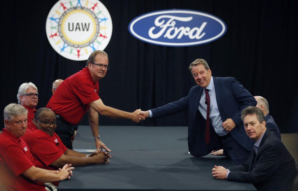 United Auto Workers President Gary Jones, left, and Ford Motor Co., Executive Chairman Bill Ford shake hands to open their contract talks Monday, July 15, 2019, in Dearborn, Mich. (AP Photo/Carlos Osorio)