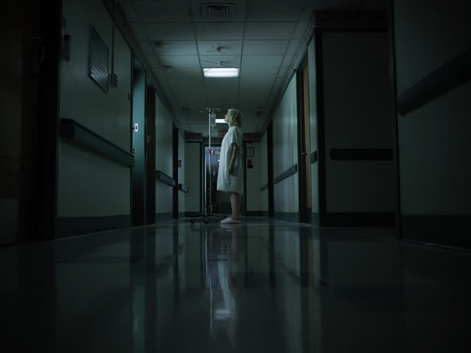 A woman standing in a hospital hallway
