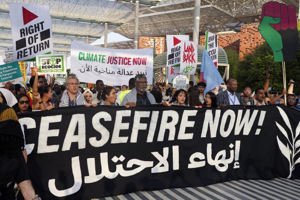 Activists demonstrate for climate justice and a ceasefire in the Israel-Hamas war at the COP28 U.N. Climate Summit, Saturday, Dec. 9, 2023, in Dubai, United Arab Emirates. (AP Photo/Rafiq Maqbool)