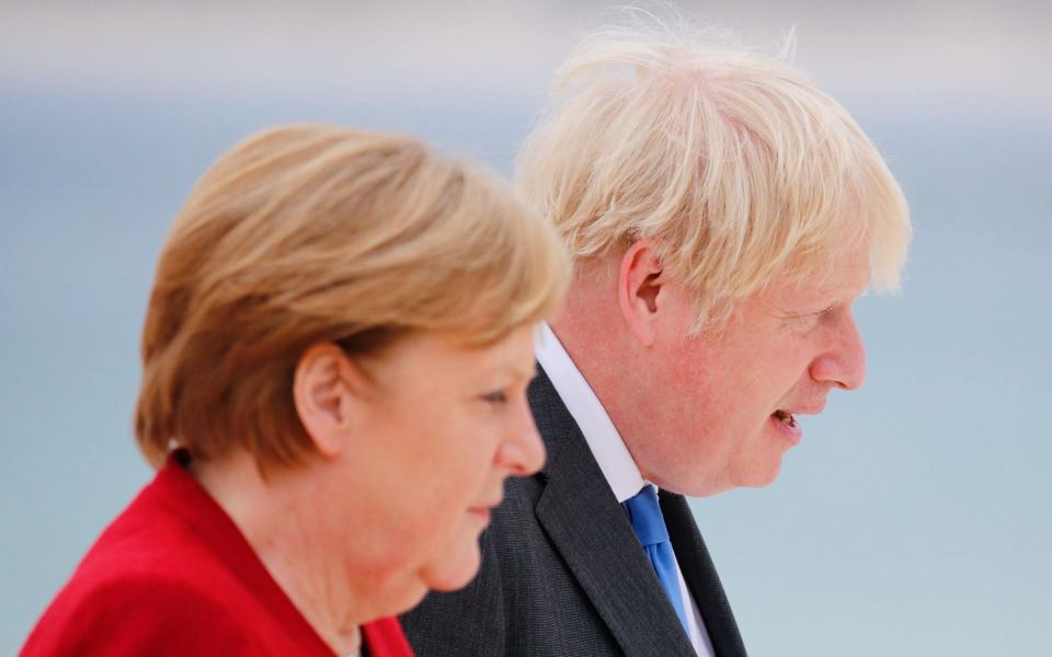 Boris Johnson and Angela Merkel on the beach of Carbis Bay - Shutterstock