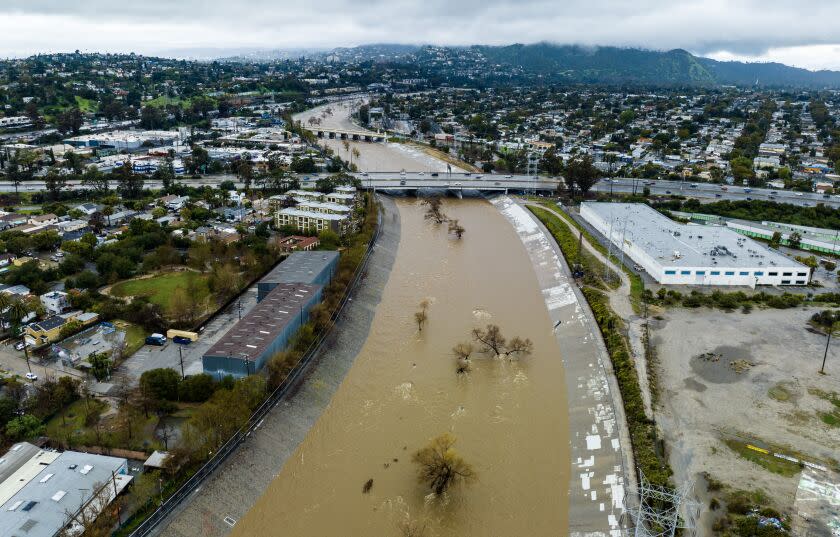LOS ANGELES, CA - FEBRUARY 25: Muddy water in a fast-moving the Los Angeles River in the Frogtown neighborhood on Saturday, Feb. 25, 2023 in Los Angeles, CA. (Brian van der Brug / Los Angeles Times)