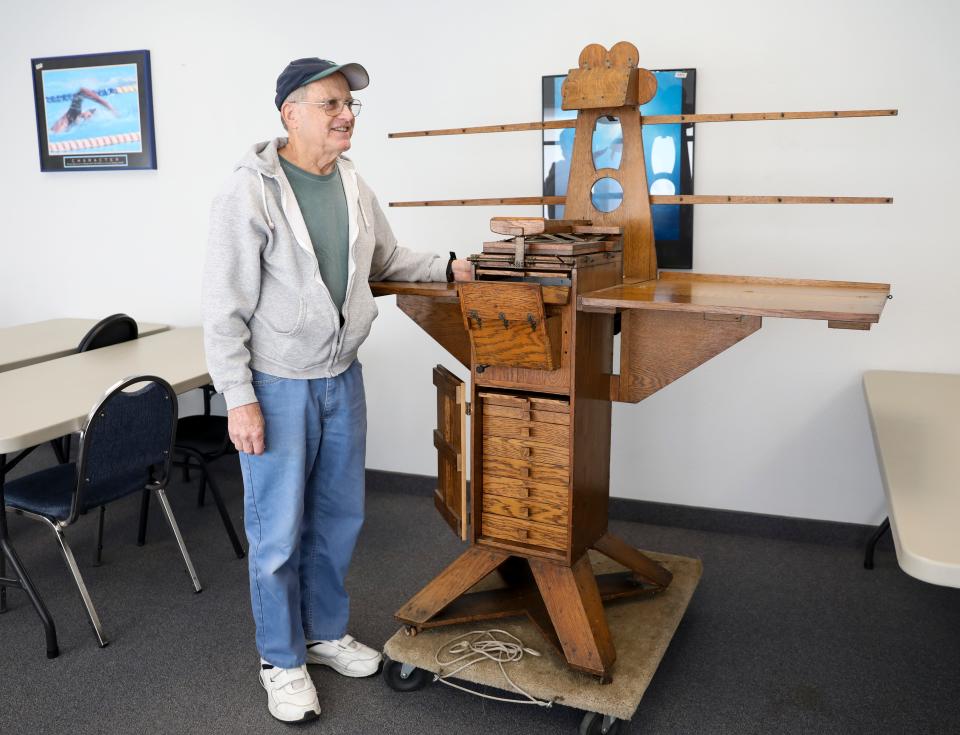 Roger Brousseau stands next to a nearly century-old photo printing device that was donated to the South Salem Senior Center. The printer was built by Guy Atherton Righter, an avid photographer who worked in the newspaper printing business in Indiana in the early to mid-1900s.