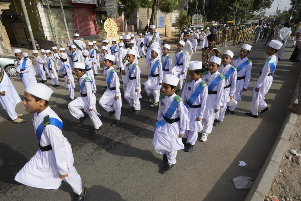 Youngsters in traditional dresses take part in a rally celebrating the birthday of Islam's Prophet Muhammad, in Karachi, Pakistan, Friday, Sept. 29, 2023. Thousands of Muslims take part in religious processions, ceremonies and distributing free meals among the poor to mark the holiday. (AP Photo/Fareed Khan)