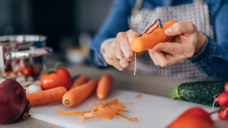 Woman peeling a carrot