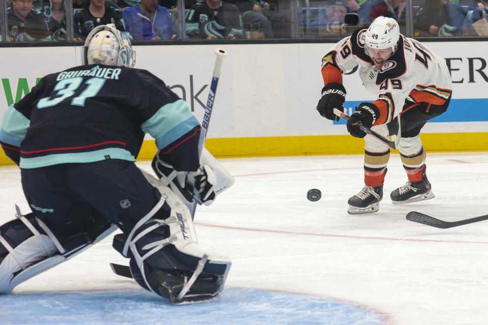 Anaheim Ducks left wing Max Jones, right shoots on Seattle Kraken goaltender Philipp Grubauer during the second period of an NHL hockey game Tuesday, March 7, 2023, in Seattle. (AP Photo/Jason Redmond)