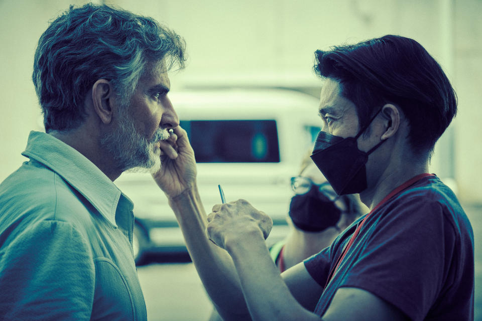 Maestro - BTS - (L to R) Bradley Cooper as Leonard Bernstein (Director/Writer/Producer) and Prosthetic makeup designer Kazu Hiro on the set of Maestro. Cr. Jason McDonald/Netflix © 2023.