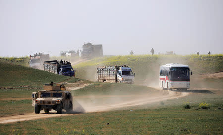 Trucks loaded with civilians ride near the village of Baghouz, Deir Al Zor province, Syria February 22, 2019. REUTERS/Rodi Said