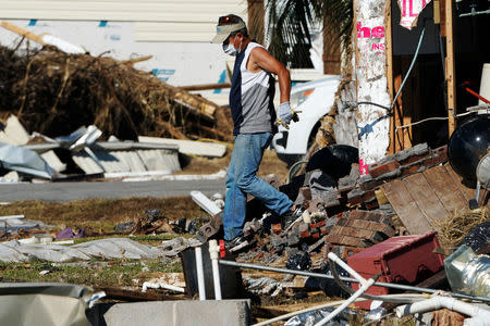 A man walks out of his home following Hurricane Michael in Mexico Beach, Florida, U.S., October 13, 2018. REUTERS/Carlo Allegri