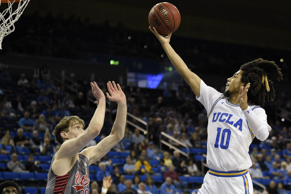 UCLA guard Tyger Campbell (10) goes up to shoot in front of Utah forward Mikael Jantunen during the first half of an NCAA college basketball game in Los Angeles, Sunday, Feb. 2, 2020. (AP Photo/Kelvin Kuo)