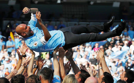 Soccer Football - Premier League - Manchester City vs Huddersfield Town - Etihad Stadium, Manchester, Britain - May 6, 2018 Manchester City manager Pep Guardiola and their players and staff celebrate winning the premier league title Action Images via Reuters/Carl Recine
