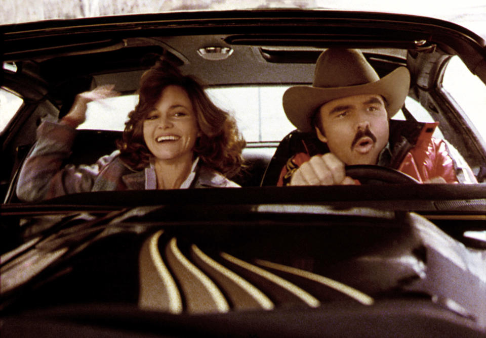 Sally and Burt in the front seat of a car in a scene from the movie