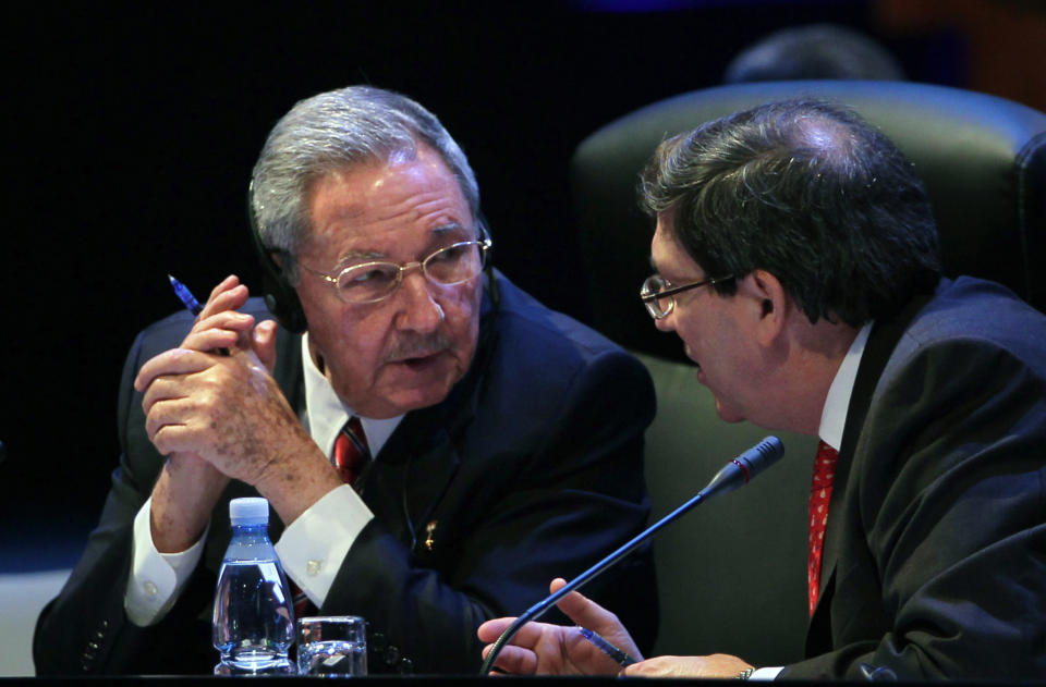 Cuba's President Raul Castro speaks to his Foreign Minister Bruno Rodriguez during a session of the CELAC Summit in Havana, Cuba, Tuesday, Jan. 28, 2014. Leaders from Latin America and the Caribbean are in Cuba to talk about poverty, inequality and hunger at the summit of the Community of Latin American and Caribbean States, or CELAC. (AP Photo/Cubadebate, Ismael Francisco)