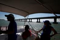 Members of SMRU Consulting, a marine mammal research group, look for Chinese white dolphins near the Hong Kong-Zhuhai-Macau bridge off Lantau island in Hong Kong, China May 30, 2018. Picture taken May 30, 2018. REUTERS/Bobby Yip