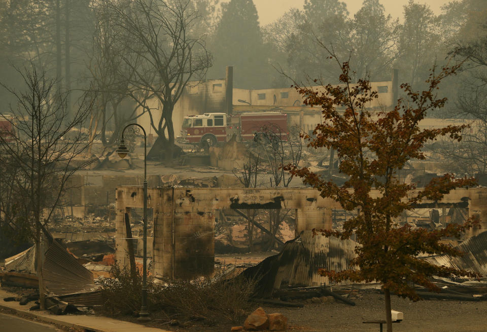 A fire truck drives through the charred ruins of Paradise, five days after flames all but obliterated the Northern California town. Image: AP