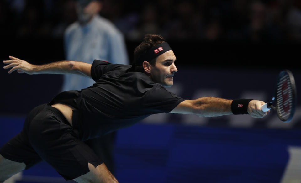 Switzerland's Roger Federer plays a return to Italy's Matteo Berrettini during their ATP World Tour Finals singles tennis match at the O2 Arena in London, Tuesday, Nov. 12, 2019. (AP Photo/Alastair Grant)