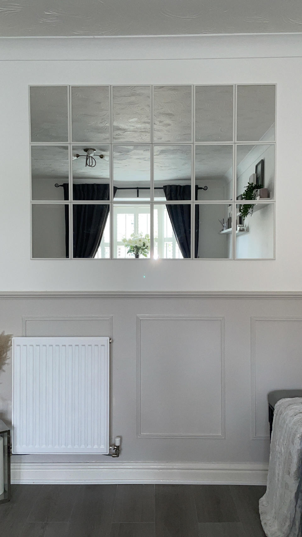 mirror wall above grey wooden panelling