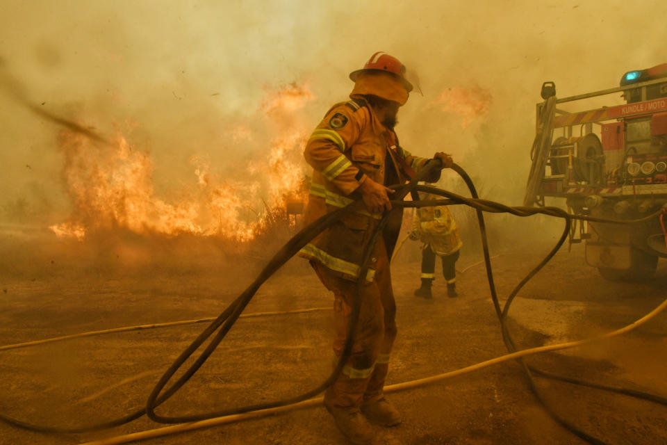 Spot fires threaten to overwhelm RFS volunteer firefighters at the Hillville fire on NSW Mid North Coast. 