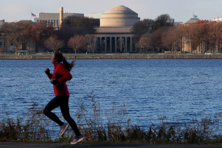 A jogger passes by the Massachusetts Institute of Technology (MIT) along the Charles River in Cambridge, Massachusetts, U.S., November 21, 2018. REUTERS/Brian Snyder