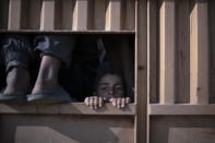 A boys ride in the back of a truck, part of a convoy evacuating hundreds out of the last territory held by Islamic State militants in Baghouz, eastern Syria, Friday, Feb. 22, 2019. (AP Photo/Felipe Dana)