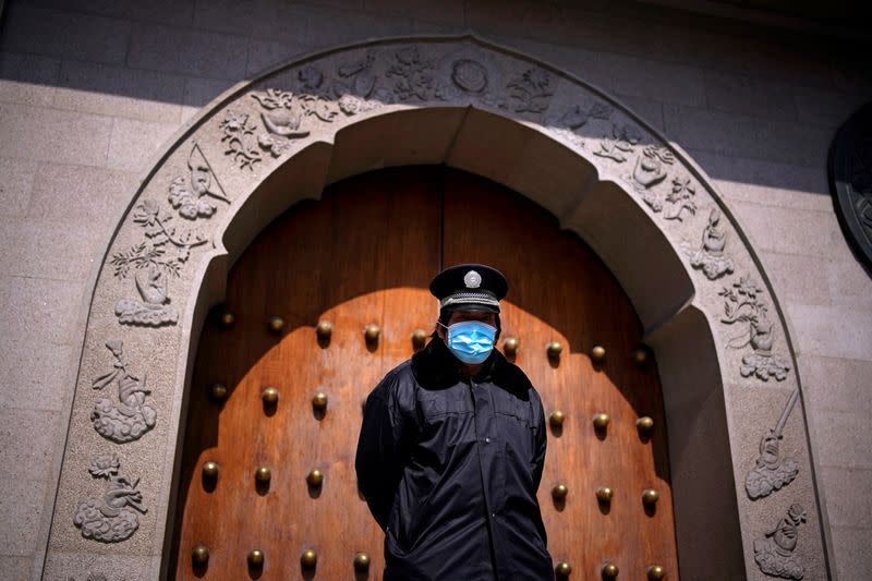 A security guard wearing a face mask is seen outside a closed temple as the country is hit by an outbreak of the novel coronavirus in Shanghai