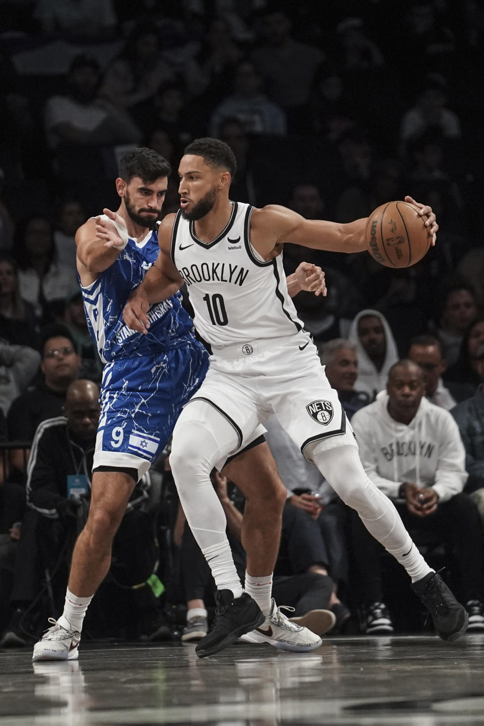 Brooklyn Nets' Ben Simmons, right, drives against Maccabi Ra'anana's Jonathan More during a preseason NBA basketball game Thursday, Oct. 12, 2023, in New York. (AP Photo/Bebeto Matthews)