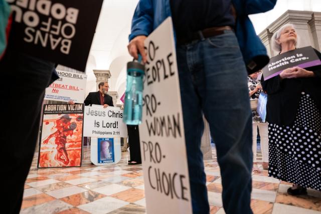 Abortion rights supporters and anti-abortion protestors demonstrate at the South Carolina capitol on 23 May as lawmakers approve a six-week ban on abortion care.  (Getty Images)