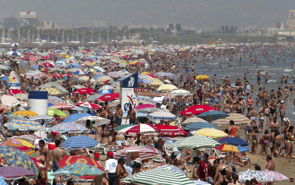 FILE - in this Thursday Aug. 7, 2003 file photo crowds flock to a beach in Valencia in south eastern Spain at the beginning of the traditional August summer holidays. Fundamental change is underway in Europe, as crisis bites and voters revolt at the polls. An entire way of life is under threat as hard times take a toll in areas that have long been central to the continent’s view of itself: state protections; sophisticated lifestyle; shiny infrastructure; health care; a secure retirement; and more broadly, a sense of being the world’s elite. (AP Photo/Ramon Espinosa, file)