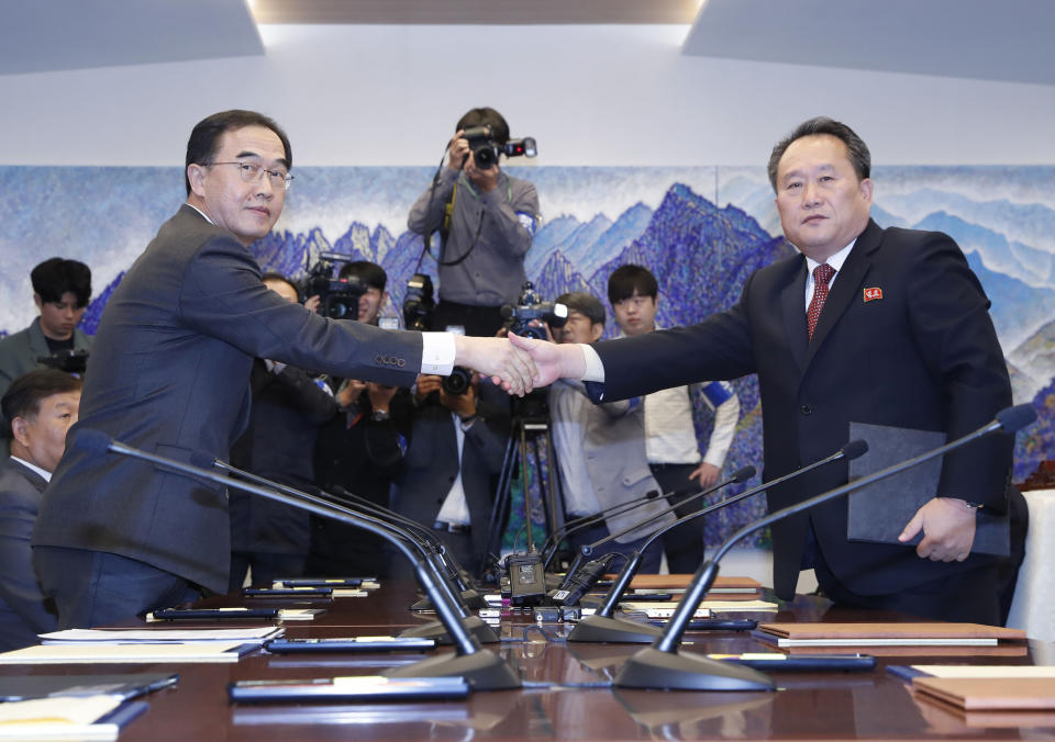 FILE - In this Oct. 15, 2018, file photo, South Korean Unification Minister Cho Myoung-gyon, left, shakes hands with his North Korean counterpart Ri Son Gwon after exchanging the joint statement during their meeting at the southern side of Panmunjom in the Demilitarized Zone, South Korea. South Korea says the United Nations Security Council has granted sanctions exemption for surveys on North Korean railroad sections the Koreas want to connect with the South. (Korea Pool/Yonhap via AP, File)