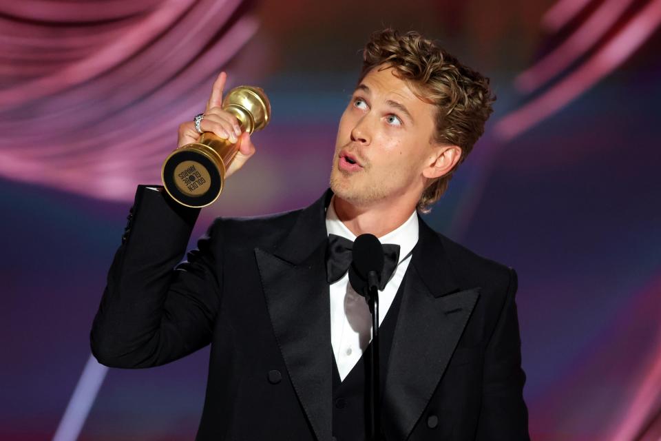 Austin Butler accepts the best actor in a movie drama for "Elvis" at the Golden Globes.