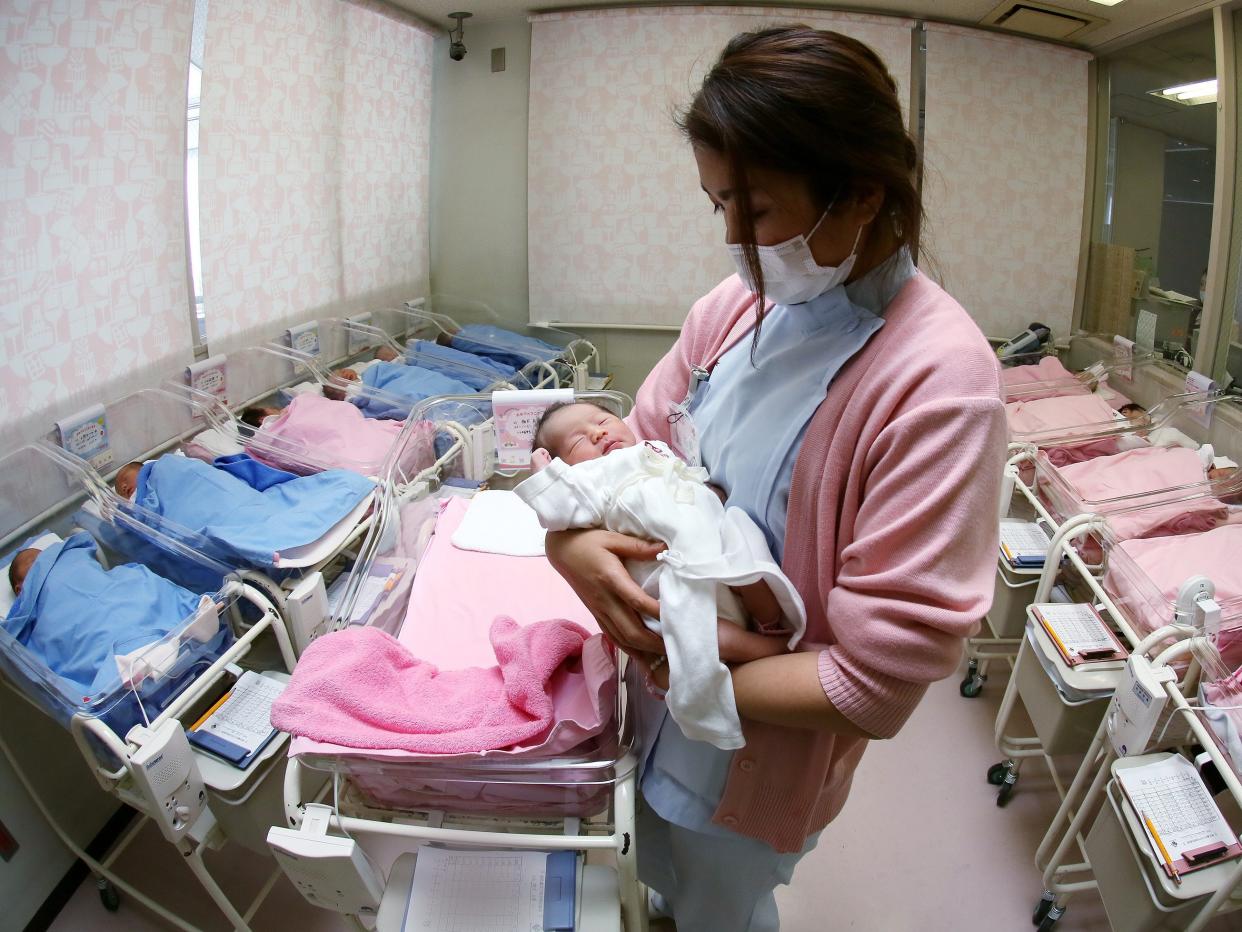 Hospital staff attend to newborn babies in Misato City