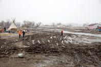 <p>Protesters walk through deep mud in the main opposition camp against the Dakota Access oil pipeline, near Cannon Ball, N.D., Feb. 22, 2017. (Photo: Terray Sylvester/Reuters) </p>