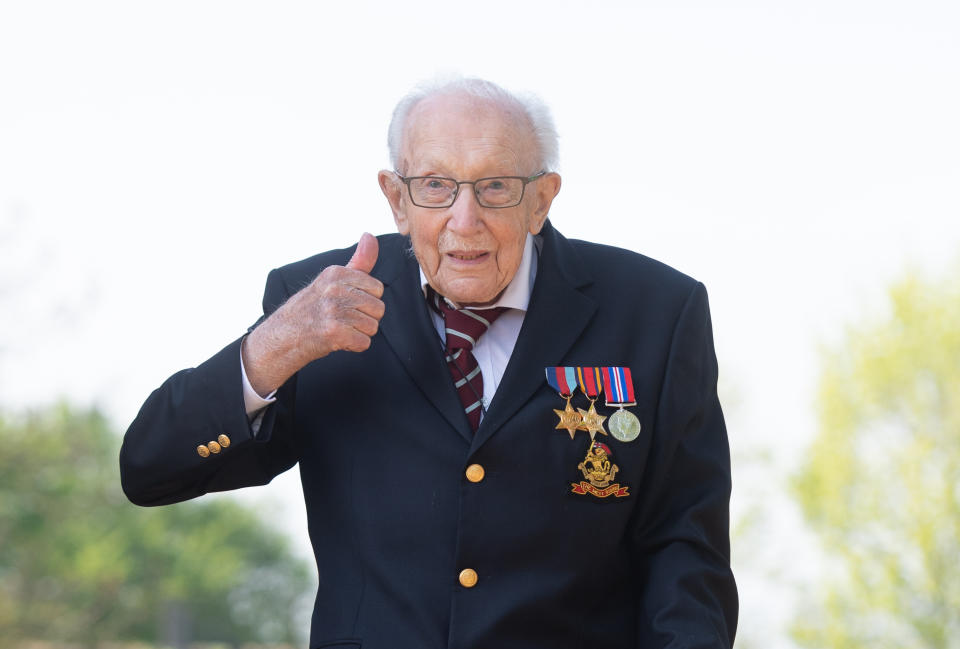 File photo dated 16/04/2020 of the then 99-year-old war veteran Captain Tom Moore at his home in Marston Moretaine, Bedfordshire, after he achieved his goal of 100 laps of his garden. Captain Sir Tom Moore has died at the age of 100 after testing positive for Covid-19, his daughters Hannah and Lucy said in a statement. Issue date: Tuesday February 2, 2021.