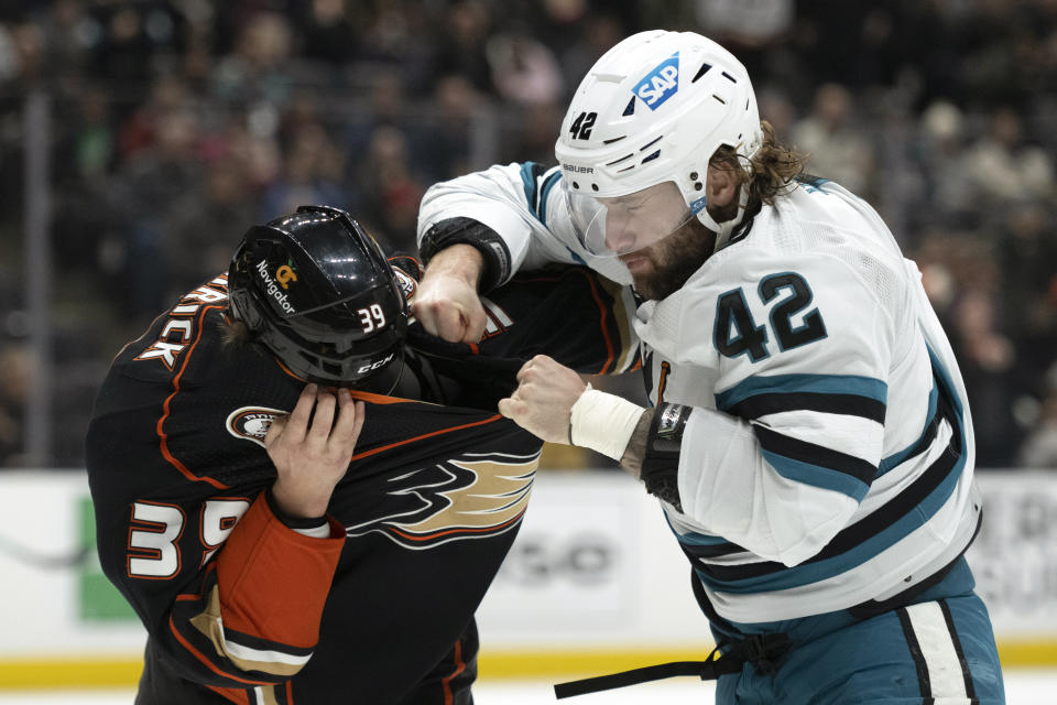 San Jose Sharks left wing Jonah Gadjovich (42) fights with Anaheim Ducks center Sam Carrick (39) during the first period of an NHL hockey game in Anaheim, Calif., Friday, Jan. 6, 2023. (AP Photo/Kyusung Gong)