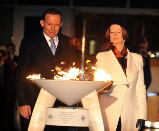 Opposition Leader Tony Abbott watches as Australian PM Julia Gillard lights a beacon to mark Queen Elizabeth II's diamond jubilee in June. Gillard and Abbott were among those voting against legalising same-sex unions