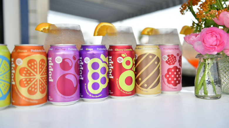 Seven cans of Poppi sodas in various flavors