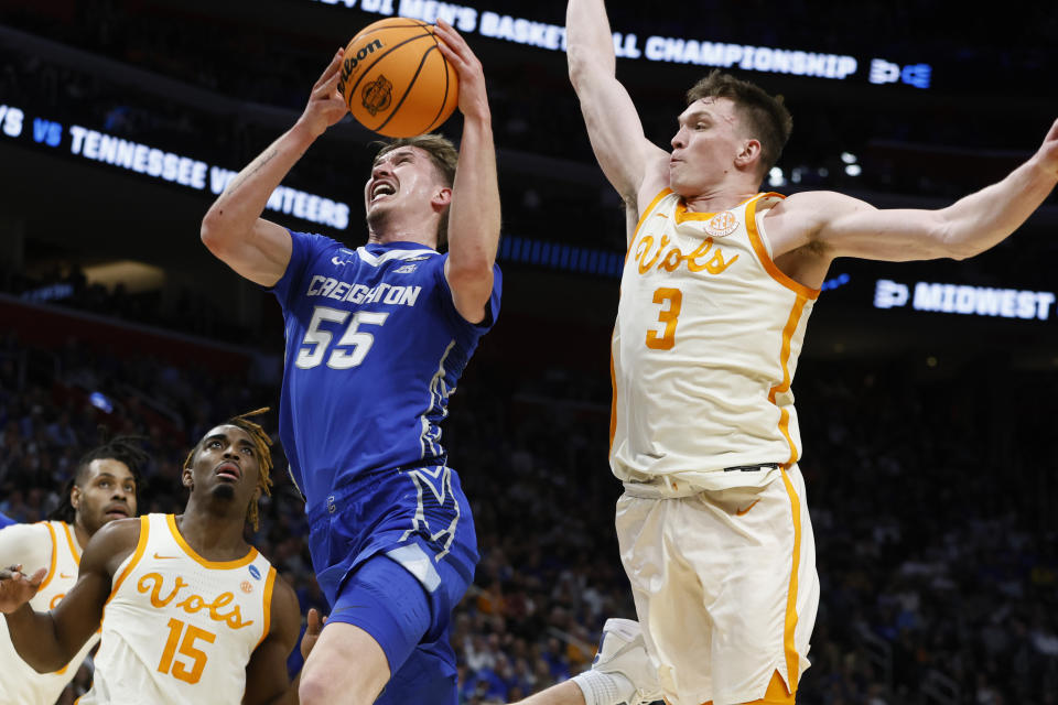 Creighton guard Baylor Scheierman (55) follows through on the play after a foul by Tennessee guard Dalton Knecht (3) during the first half of a Sweet 16 college basketball game in the NCAA Tournament, Friday, March 29, 2024, in Detroit. (AP Photo/Duane Burleson)