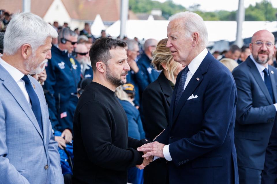 US President Joe Biden (R) shakes hands with Ukraine’s President Volodymyr Zelensky (L) during the International commemorative ceremony at Omaha Beach marking the 80th anniversary of the World War II “D-Day” Allied landings in Normandy, in Saint-Laurent-sur-Mer, in northwestern France, on June 6, 2024 (AFP via Getty Images)