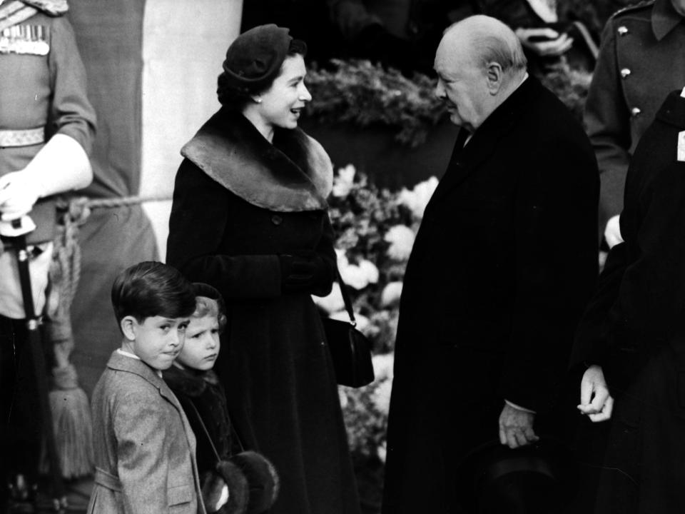 Queen Elizabeth and Winston Churchill in 1953 with her two sons next to her