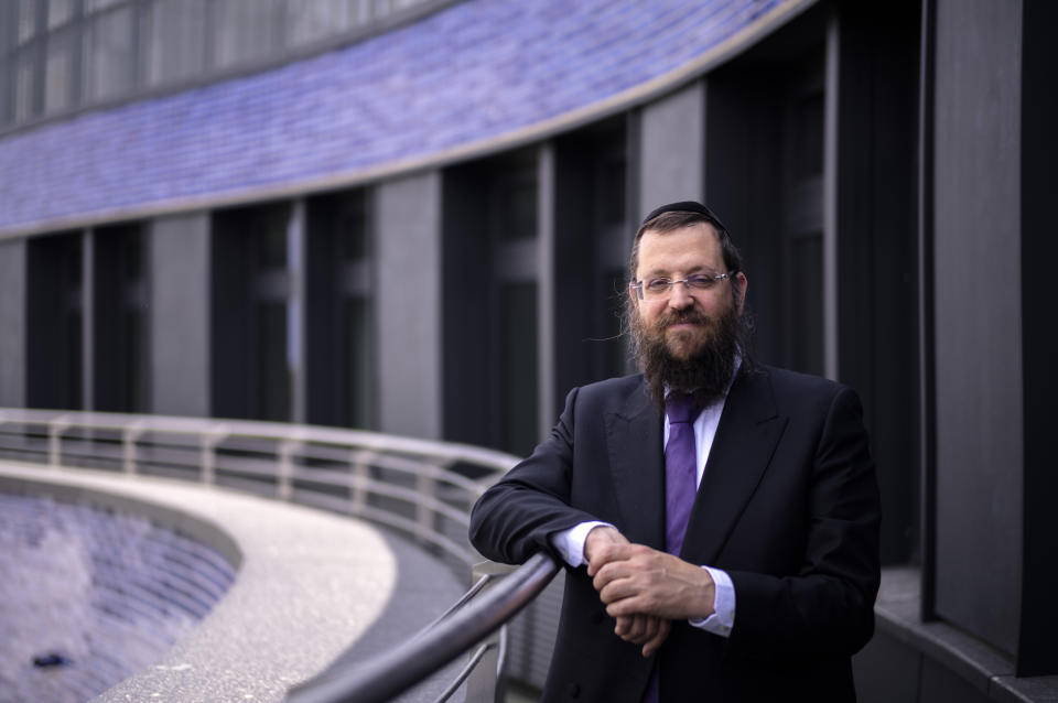Rabbi Yehuda Teichtal poses on the balcony of the curved building of the new Jewish educational and cultural complex in Berlin, Germany, Monday, June 12, 2023. The Pears Jewish Campus, run by the local Chabad community, is located in the German capital's Wilmersdorf neighbourhood and will be officially opened Sunday, June 25, 2023. (AP Photo/Markus Schreiber)