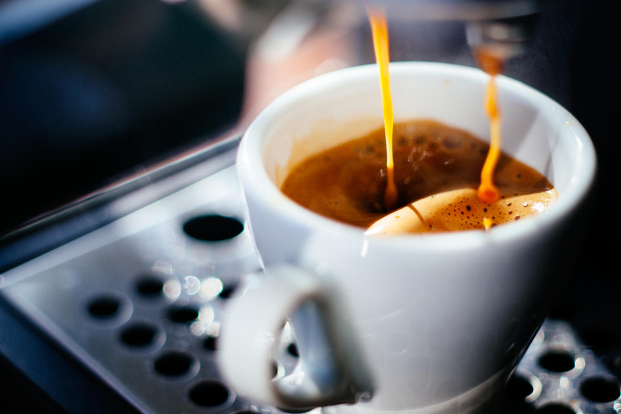 Espresso shot pouring out of a espresso machine.