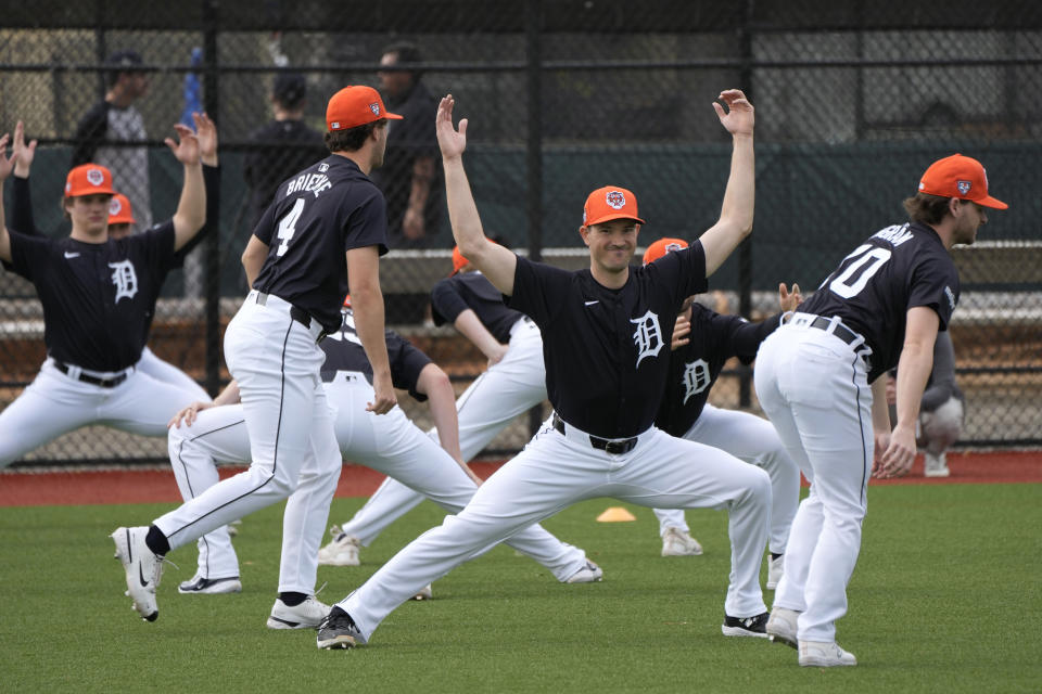 Detroit Tigers pitcher Drew Anderson, center, stretches during a baseball spring training workout Friday, Feb. 16, 2024, in Lakeland, Fla. (AP Photo/Charlie Neibergall)
