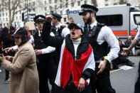 Police officers attempt to move protestors from the road as they demonstrate against UK involvement in any military escalation in Syria on Whitehall in London, Britain April 13, 2018. REUTERS/Simon Dawson