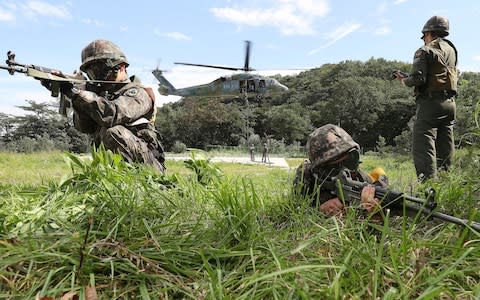 South Korean army soldiers aim their machine guns during the annual Ulchi Freedom Guardian exercise in Yongin, South Korea - Credit: Hong Gi-won/Yonhap via AP
