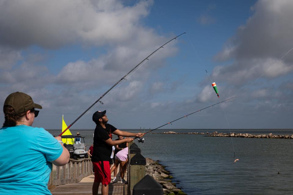 Dr. Catherine Boston, a pediatric oncologist at Driscoll Children's Hospital, watches Andrew Banda, 19, of Brownsville, cast a line into Copano Bay on Wednesday, July 12, 2023, at Camp Aranzazu in Rockport, Texas.