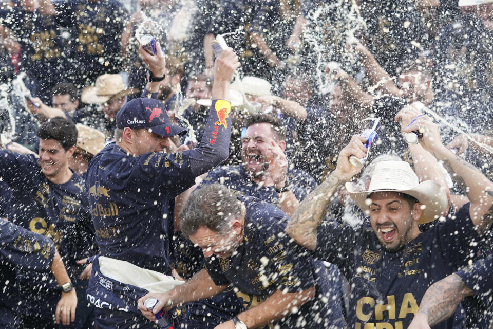 Red Bull driver Max Verstappen, of the Netherlands, celebrates with the Red Bull team following the Formula One U.S. Grand Prix auto race at Circuit of the Americas, Sunday, Oct. 23, 2022, in Austin, Texas. Verstappen won the race and team Red Bull won the constructors' championship. (AP Photo/Darron Cummings)